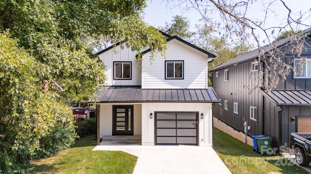 modern farmhouse style home featuring a front yard and a garage