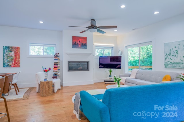 living room featuring ceiling fan, a healthy amount of sunlight, and hardwood / wood-style flooring