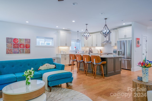 living room with light hardwood / wood-style floors and sink