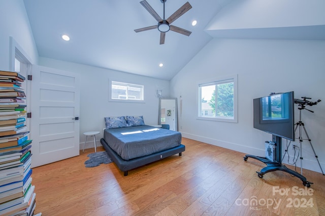 bedroom with ceiling fan, light hardwood / wood-style flooring, and high vaulted ceiling