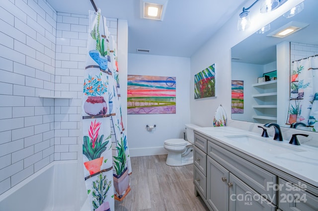 full bathroom with vanity, hardwood / wood-style flooring, toilet, and shower / bath combo with shower curtain