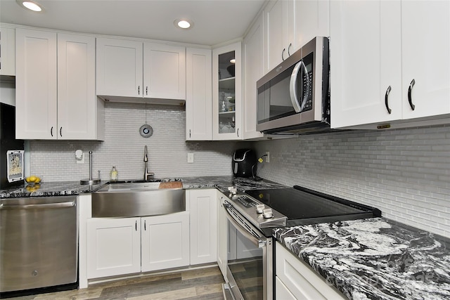 kitchen featuring stainless steel appliances, sink, and white cabinets