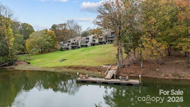 dock area with a water view and a lawn