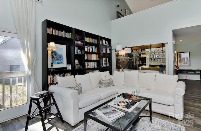 living room with a high ceiling and wood-type flooring