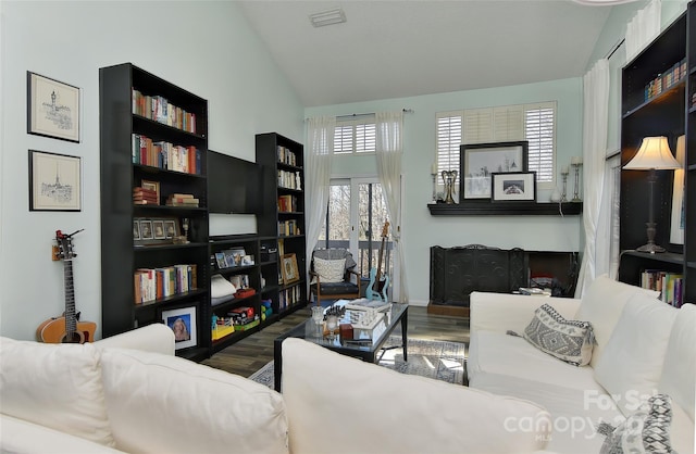 living room with wood-type flooring and vaulted ceiling