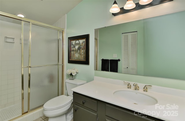 bathroom with vanity, a shower with shower door, and toilet