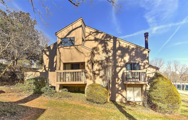 back of property with a balcony