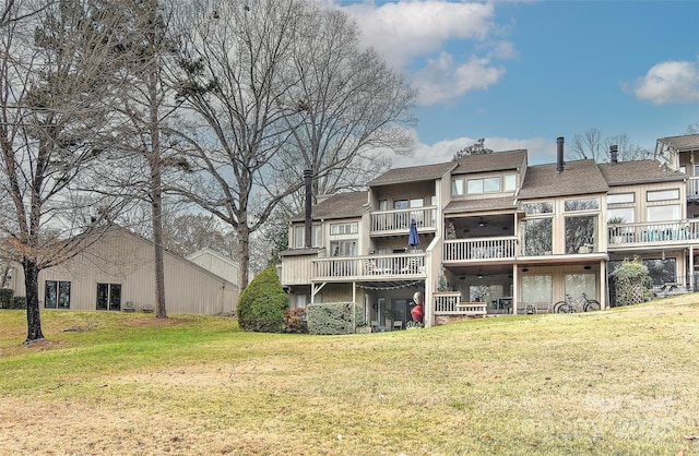 rear view of house featuring a lawn