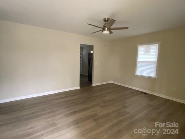 unfurnished room featuring dark hardwood / wood-style floors and ceiling fan