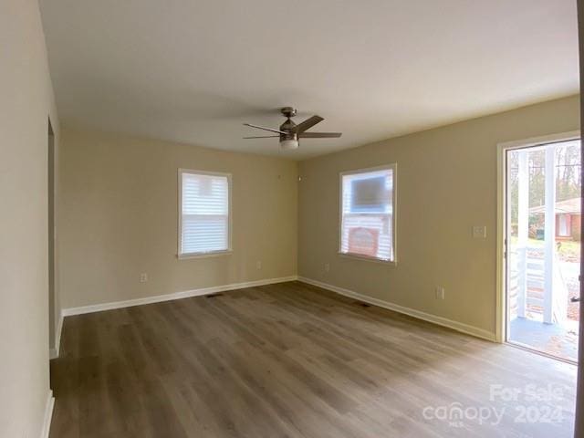 spare room featuring dark hardwood / wood-style floors and ceiling fan