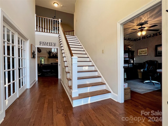 stairs featuring hardwood / wood-style floors and ceiling fan