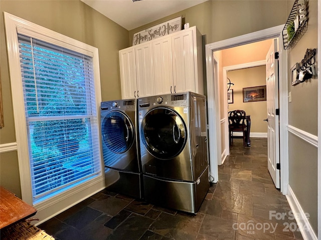 laundry room with cabinets and washing machine and dryer