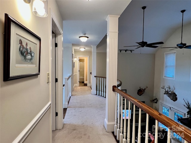 corridor with light colored carpet and lofted ceiling