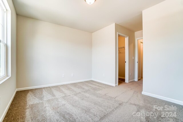 unfurnished room featuring light carpet