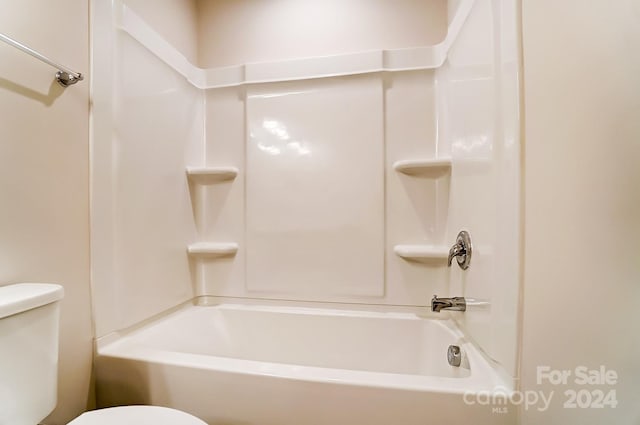 bathroom featuring toilet and shower / washtub combination