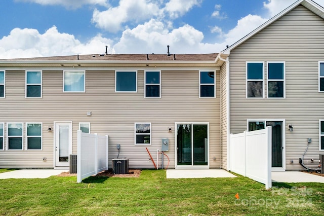 rear view of house featuring a lawn and a patio