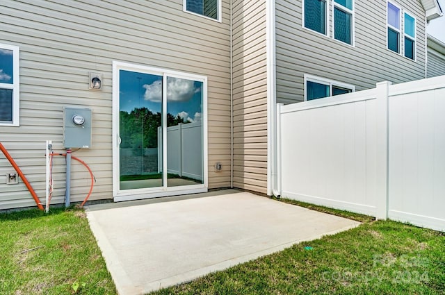 view of exterior entry with a patio