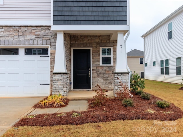 view of exterior entry with a garage