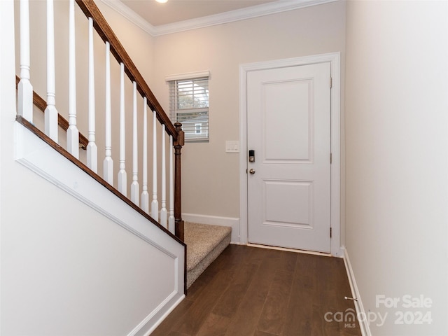 entrance foyer with dark hardwood / wood-style floors and ornamental molding