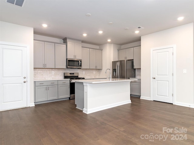 kitchen with gray cabinets, dark wood-type flooring, and stainless steel appliances