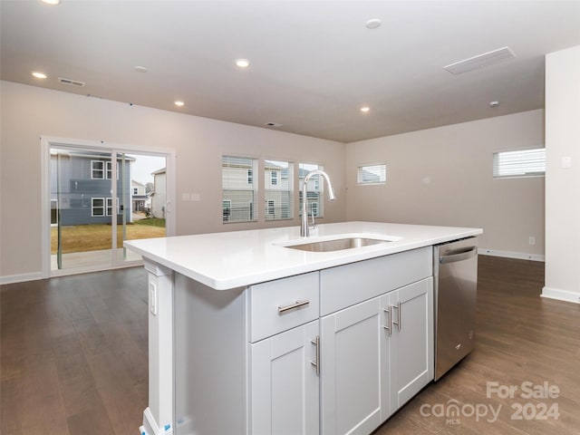 kitchen featuring a kitchen island with sink, dark wood-type flooring, sink, stainless steel dishwasher, and white cabinetry