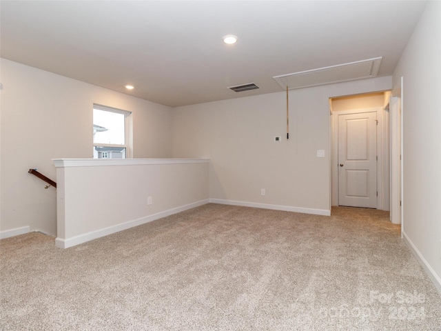 unfurnished room with light carpet