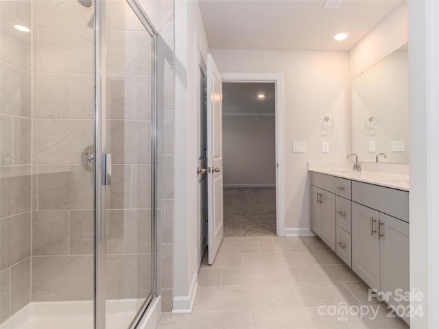 bathroom featuring tile patterned flooring, vanity, and an enclosed shower