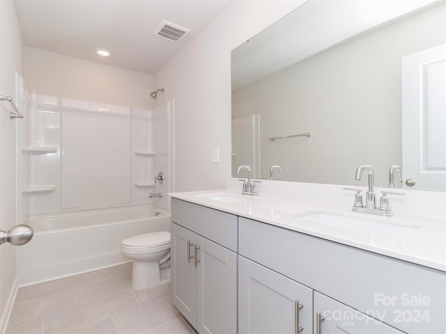 full bathroom with shower / tub combination, tile patterned floors, vanity, and toilet