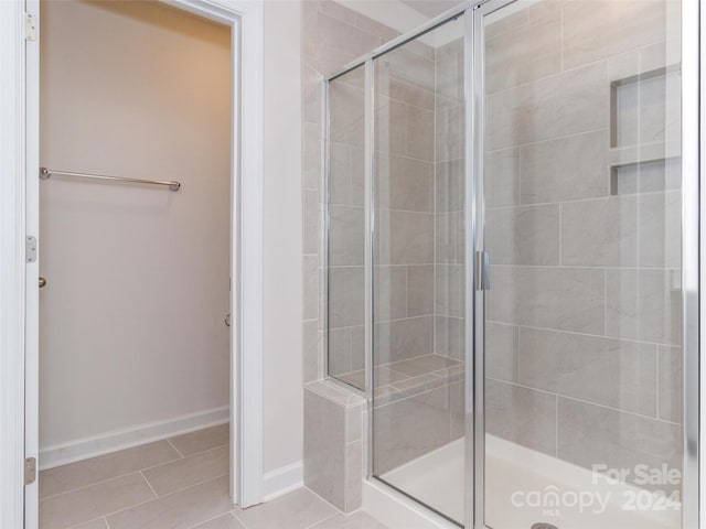 bathroom with tile patterned floors and walk in shower