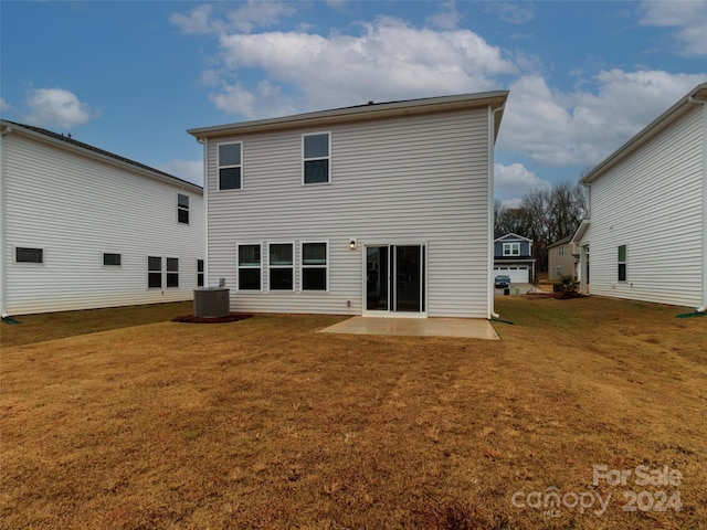 rear view of property with a yard, central AC, and a patio area