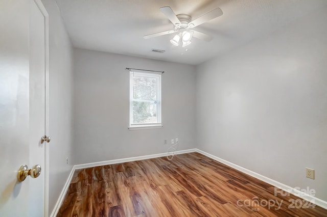 spare room with ceiling fan and wood-type flooring