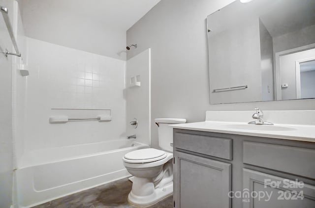 full bathroom featuring bathing tub / shower combination, vanity, and toilet