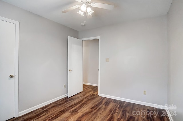 spare room featuring dark hardwood / wood-style floors and ceiling fan