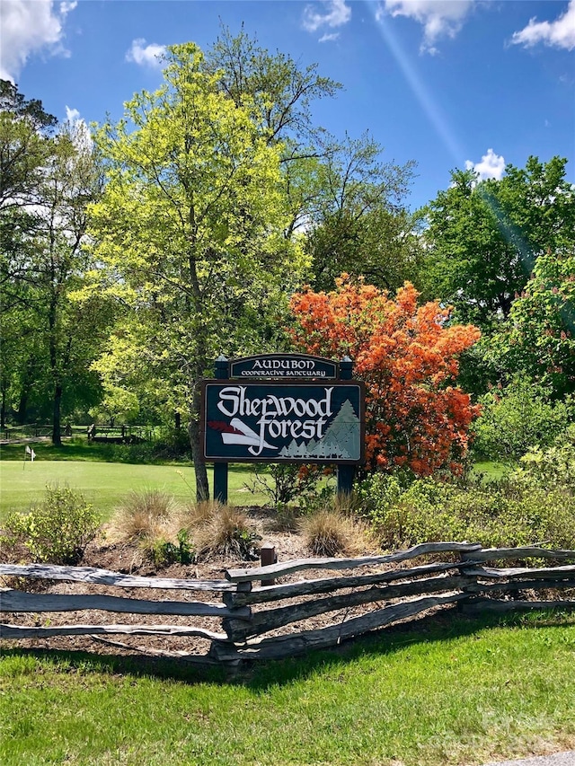 community / neighborhood sign with a lawn