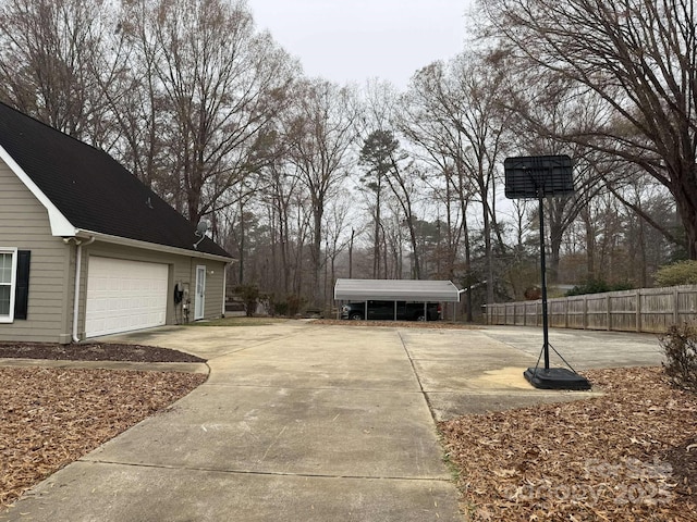 view of yard with a garage and a carport