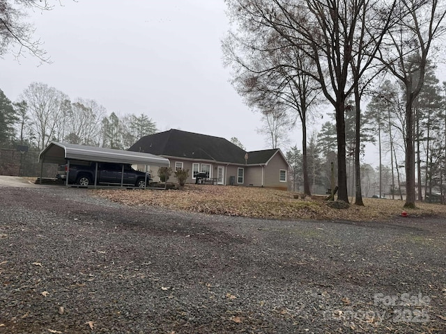 ranch-style house featuring a carport