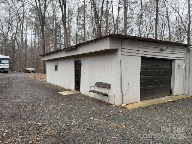 view of property exterior with a garage and an outbuilding