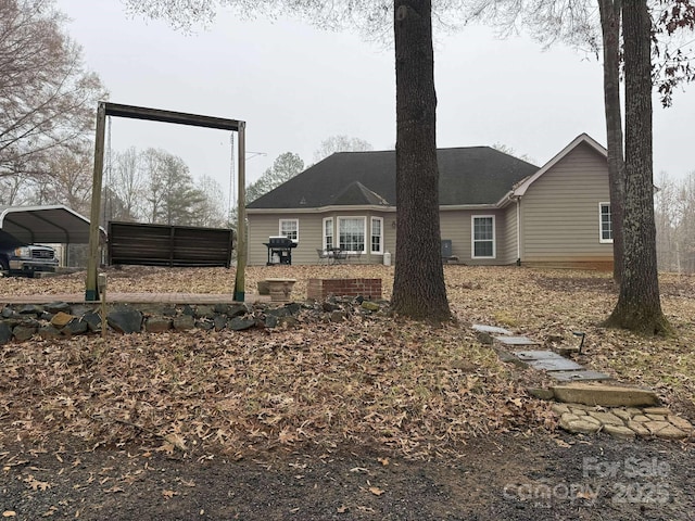 back of property featuring a carport