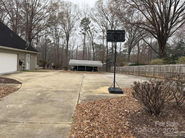 view of yard with a garage and a carport