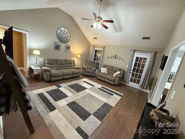 living room featuring ceiling fan and vaulted ceiling