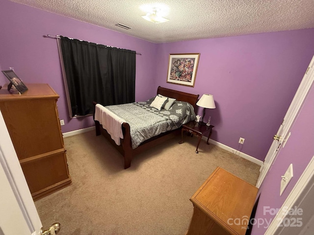 bedroom with a textured ceiling and carpet