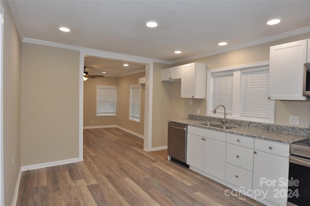 kitchen featuring light stone countertops, sink, stainless steel appliances, light hardwood / wood-style flooring, and white cabinets