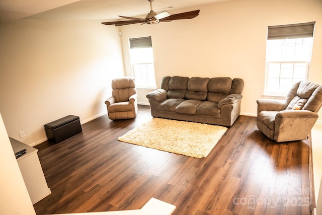 living room featuring dark hardwood / wood-style floors and ceiling fan