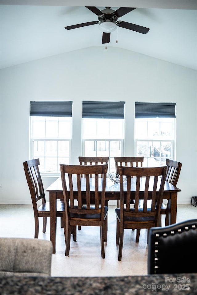 dining room with ceiling fan and lofted ceiling