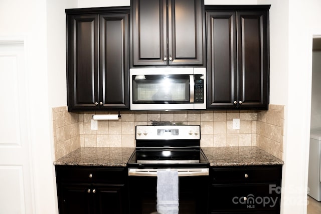 kitchen featuring tasteful backsplash, light stone countertops, stainless steel appliances, and washer / dryer