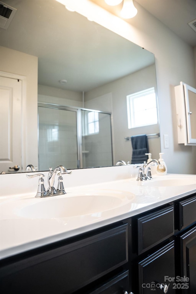 bathroom featuring vanity and an enclosed shower