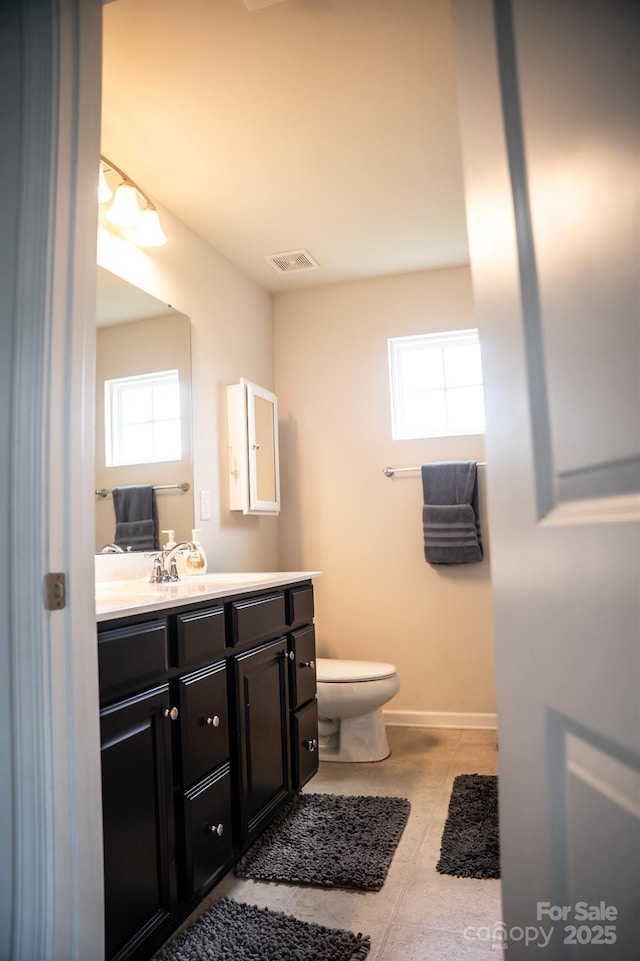 bathroom with tile patterned flooring, vanity, and toilet