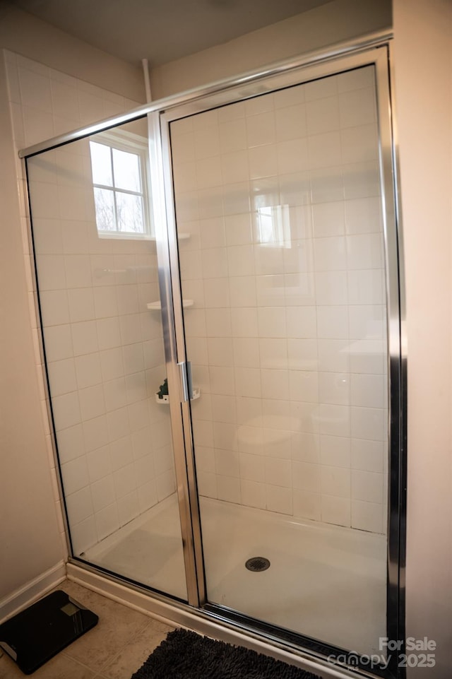 bathroom with tile patterned floors and walk in shower