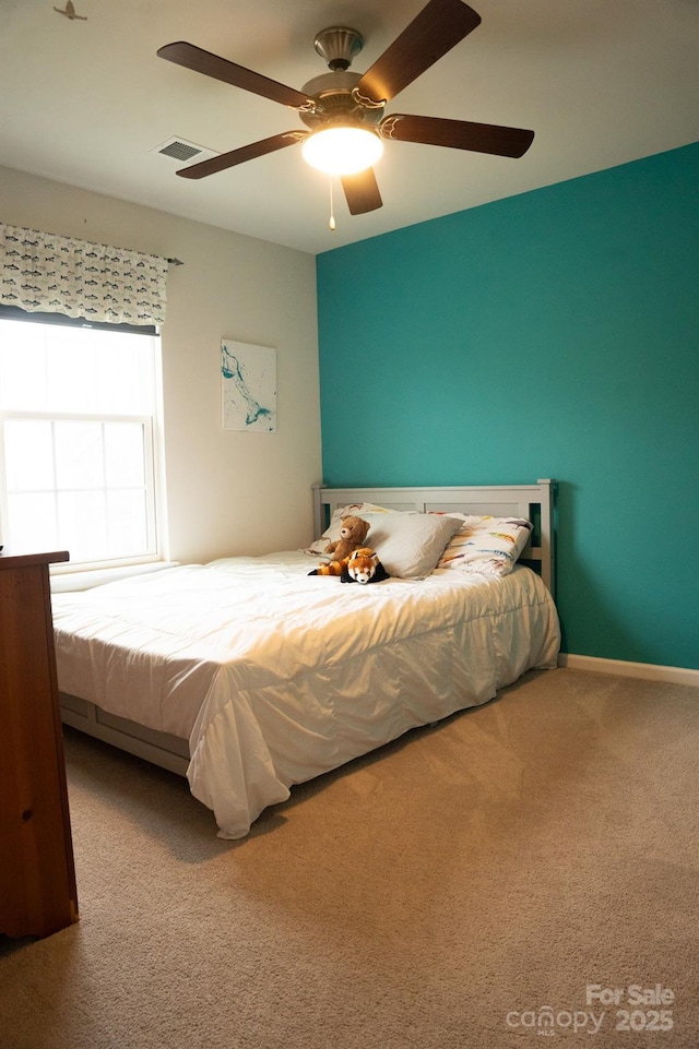 bedroom featuring ceiling fan and carpet