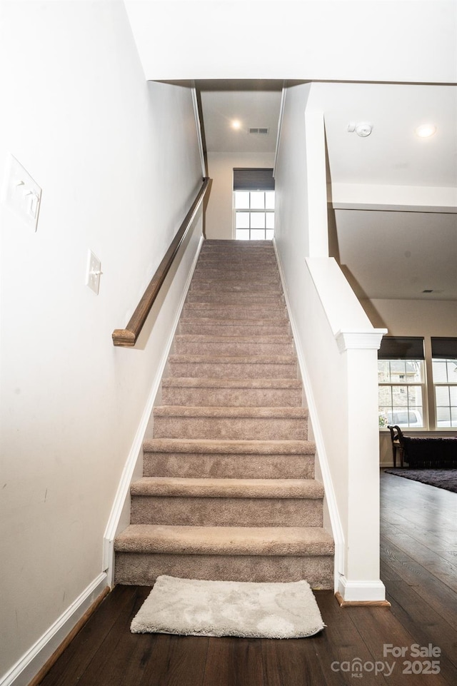 stairway with hardwood / wood-style floors